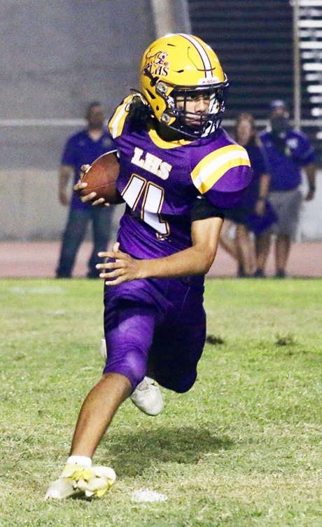 Lemoore quarterback Ty Chambers runs for a short gain in the second quarter of Friday night's season opener against visiting Washington Union.